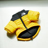 A yellow and black puffer coat for a dog, shown flat against a white background.