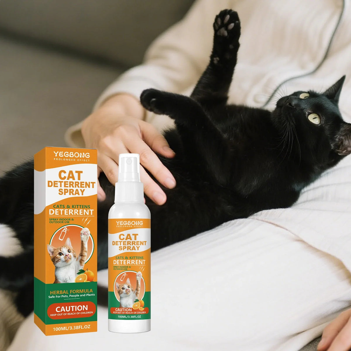 A bottle of Yegbong Cat Deterrent Spray is held by a person, with a black cat resting nearby.