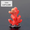 Bright red and orange resin coral decoration with a textured surface mounted on a dark base
