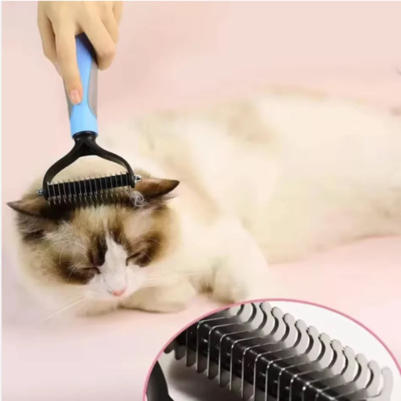 A hand is using a blue and black stainless steel pet deshedding comb on a cat's fur.