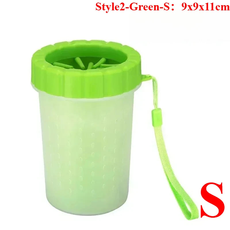 A lime green portable paw washer cup with a silicone brush and attached cord.