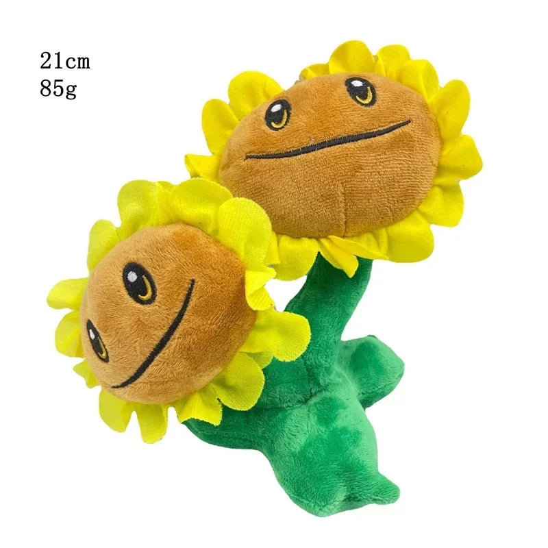 A plush toy shaped like a sunflower with a smiling face and green stem.