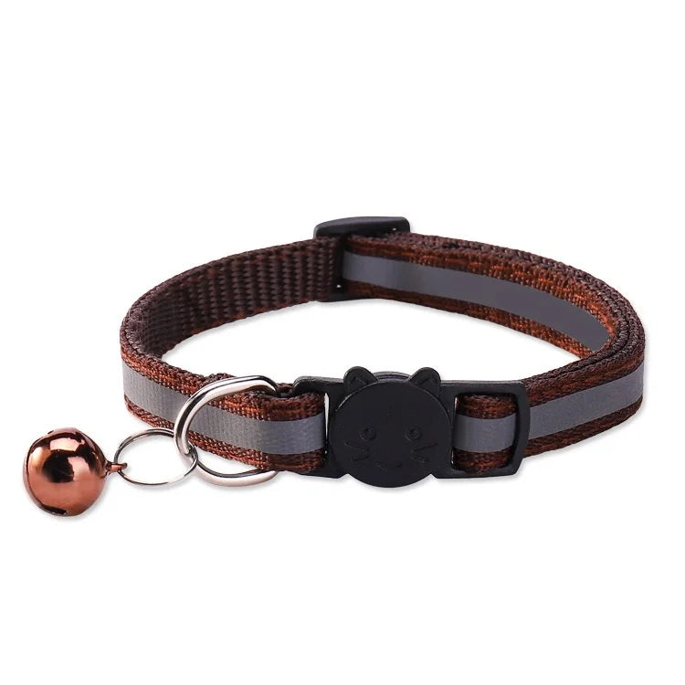 A brown and gray safety breakaway cat collar with a bell attached to a leather strap.