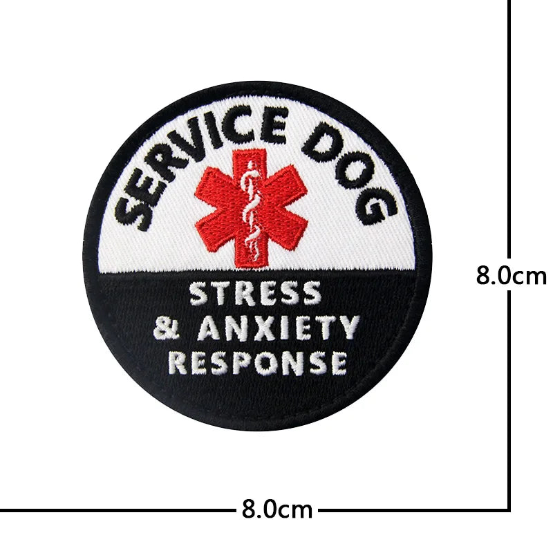 Black embroidered patch for service dog training with red cross and text indicating stress & anxiety response.