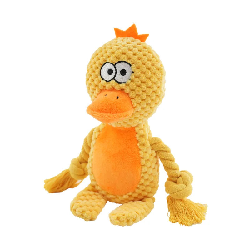 A yellow plush toy resembling a bird or duck with orange accents and rope features.