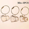 Three glass cat figurines with gold-colored loops and jump rings for pet hair keepsakes