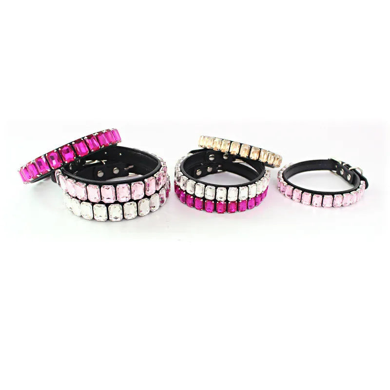 A set of glittering rhinestone dog collars featuring pink and clear crystal accents.