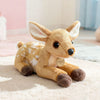 A soft plush toy of a fox with white markings lying on a light pink rug.