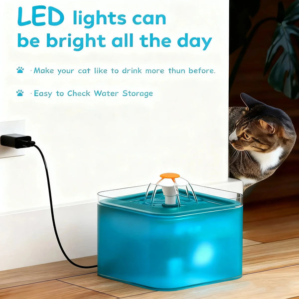A blue automatic pet water fountain with an orange LED light is placed on a wooden surface.