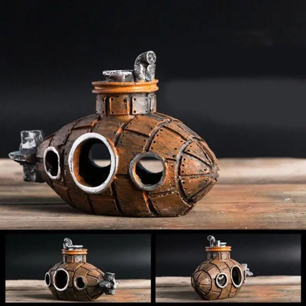 A handcrafted resin submarine ornament with an aged bronze finish resting on a wooden surface.