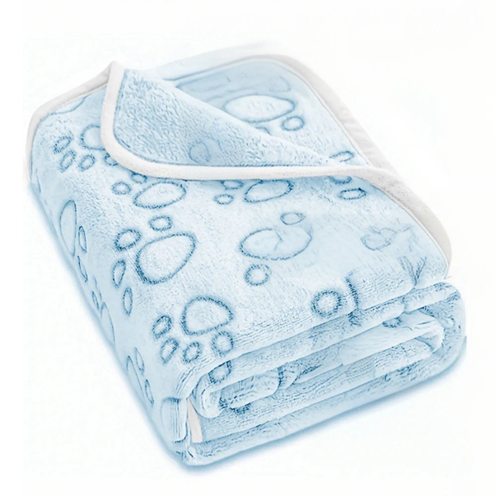 Light blue ultra-soft pet blanket with a paw print pattern folded neatly.