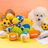 A white poodle sits next to a collection of colorful squeaky latex balls for dogs on a yellow surface.