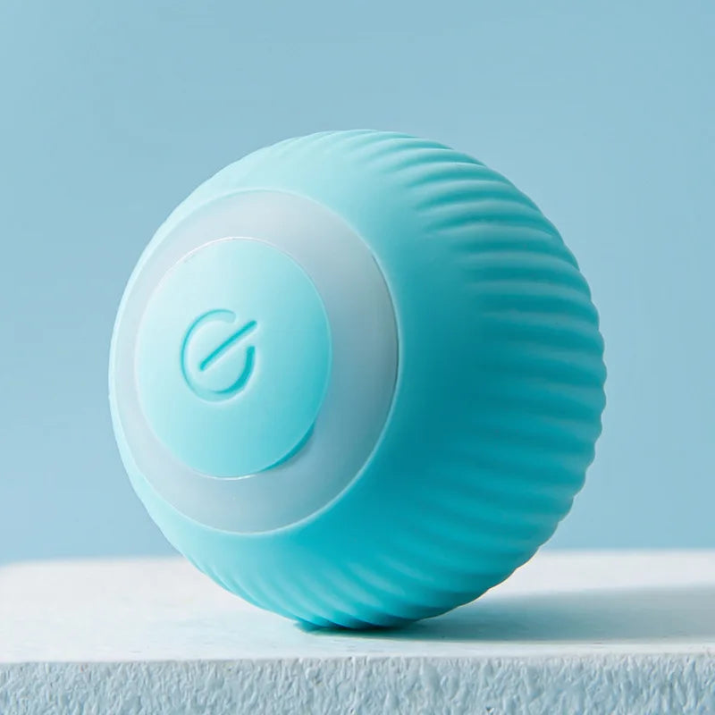 A light blue, textured ball-shaped cat toy with a circular button on a white surface.