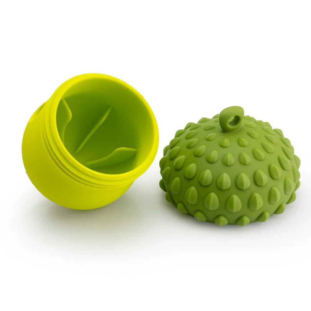 A bright yellow silicone slow feeder puzzle toy for pets, next to a green textured ball.