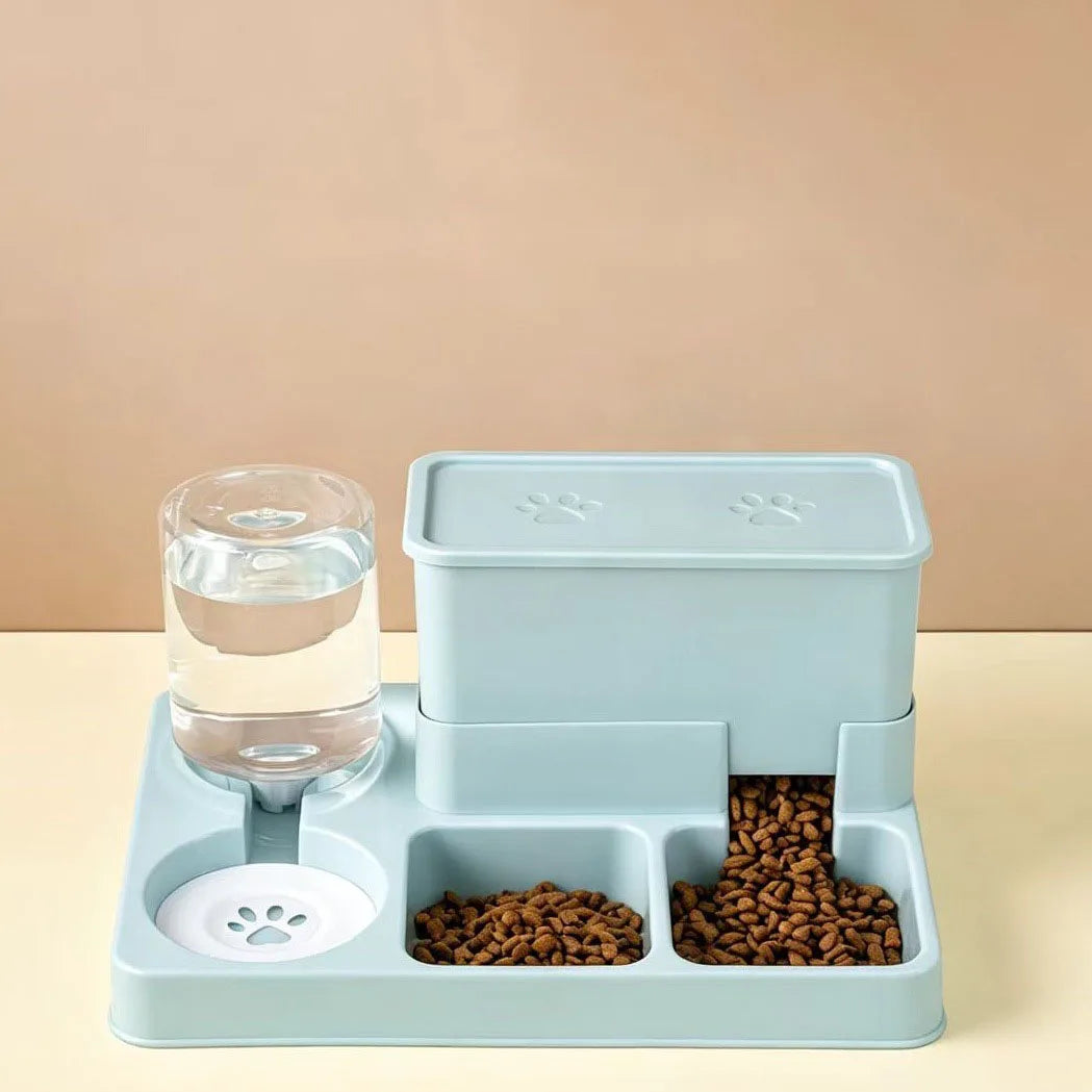 A light blue automatic cat feeder and water fountain set with dry food visible in the compartments.