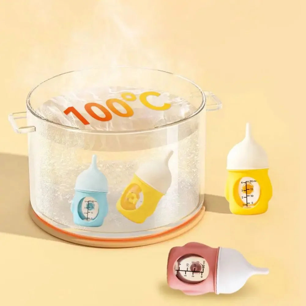 A clear pot of water is boiling at 100 degrees Celsius with silicone pet nursing bottles inside.
