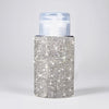 A clear pump bottle with a silver diamond-encrusted exterior and a translucent cap.