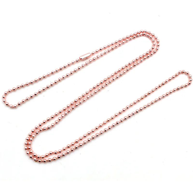 A set of ball necklaces with a rose gold and silver plated finish displayed on a white background.