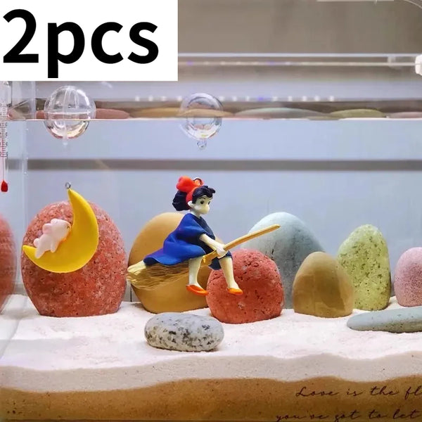 Two floating ornaments of a mermaid and an aquarium diver are displayed on a white surface.