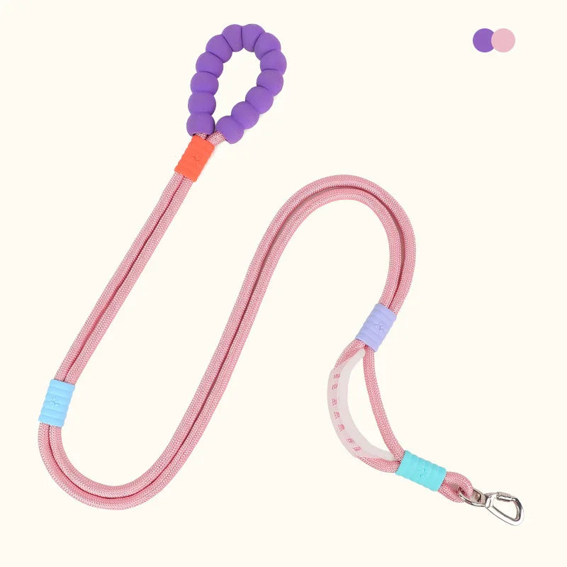 A pink adjustable hands-free dog leash with purple and orange accents.