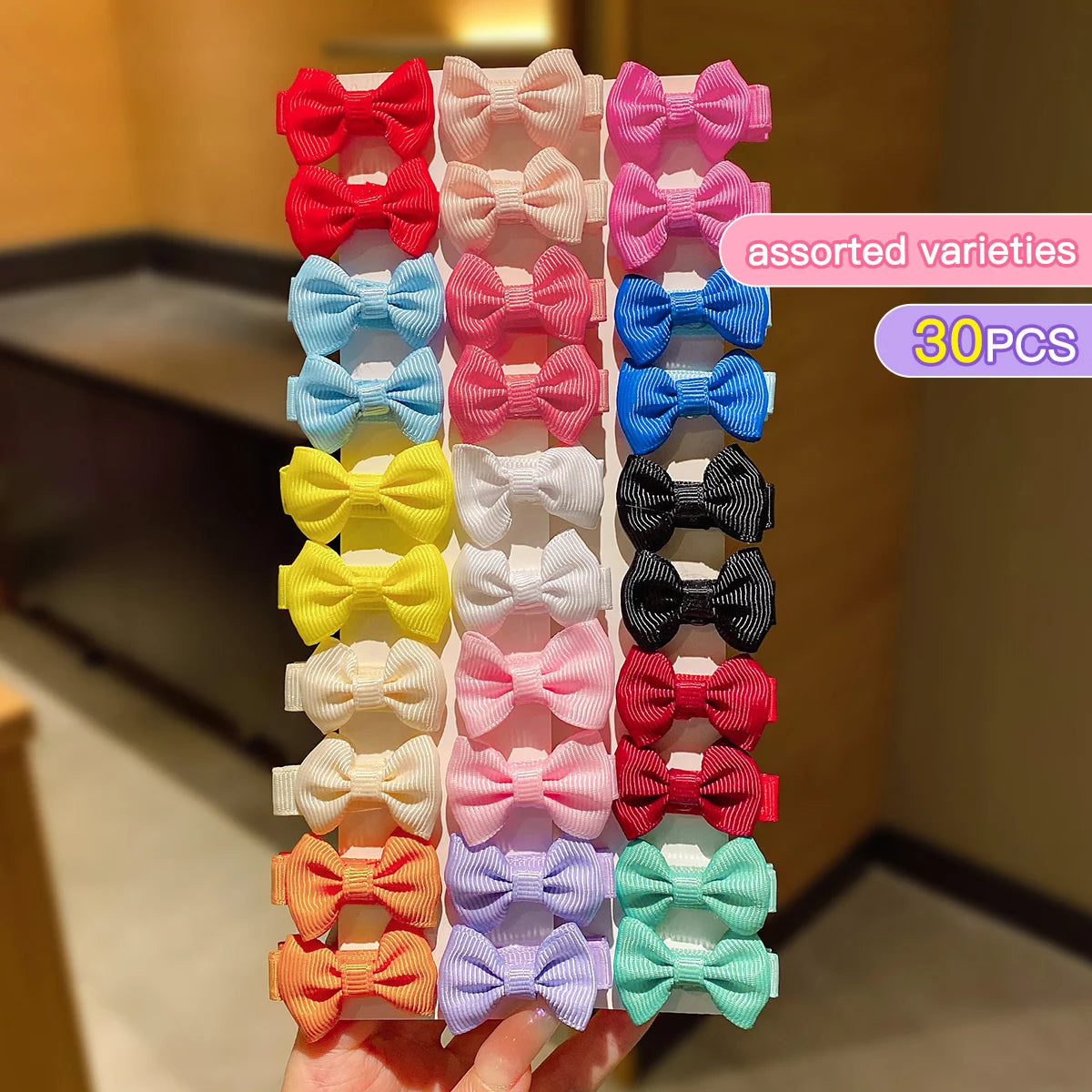 Assorted varieties of pink, red, blue, yellow, and white fabric hair clips in a 30-piece set