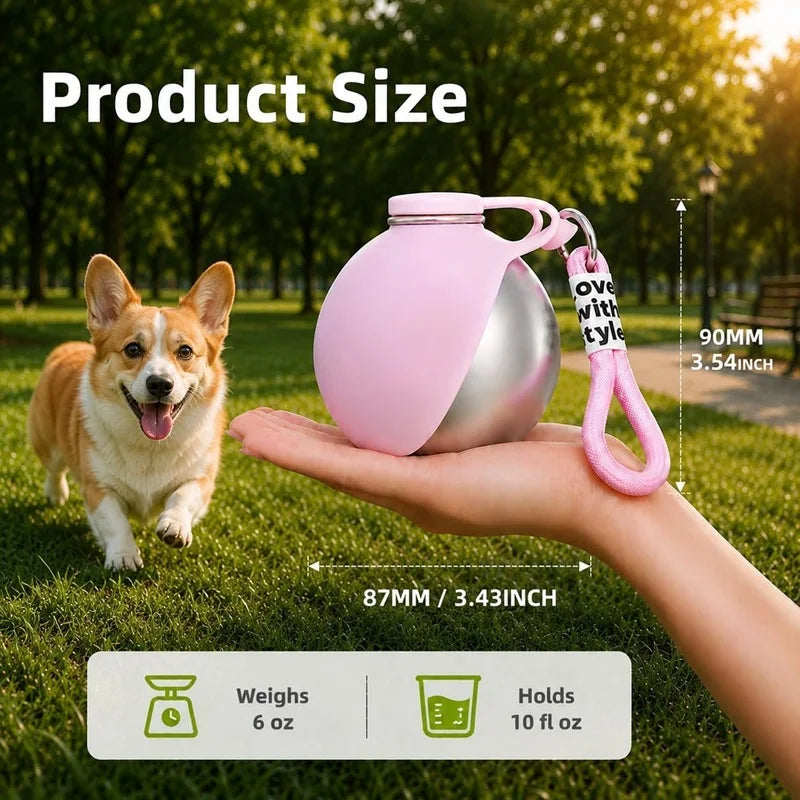 A hand holds a pink portable stainless steel dog water bottle with a built-in bowl, demonstrating its size.