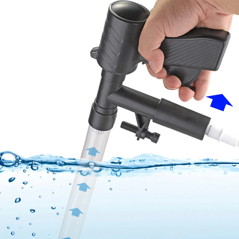 A hand holds a black manual aquarium water change pump and gravel cleaner, which is shown operating underwater.