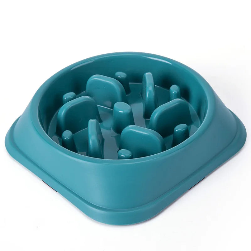 A teal non-slip slow feeder bowl for dogs with various puzzle shapes inside.