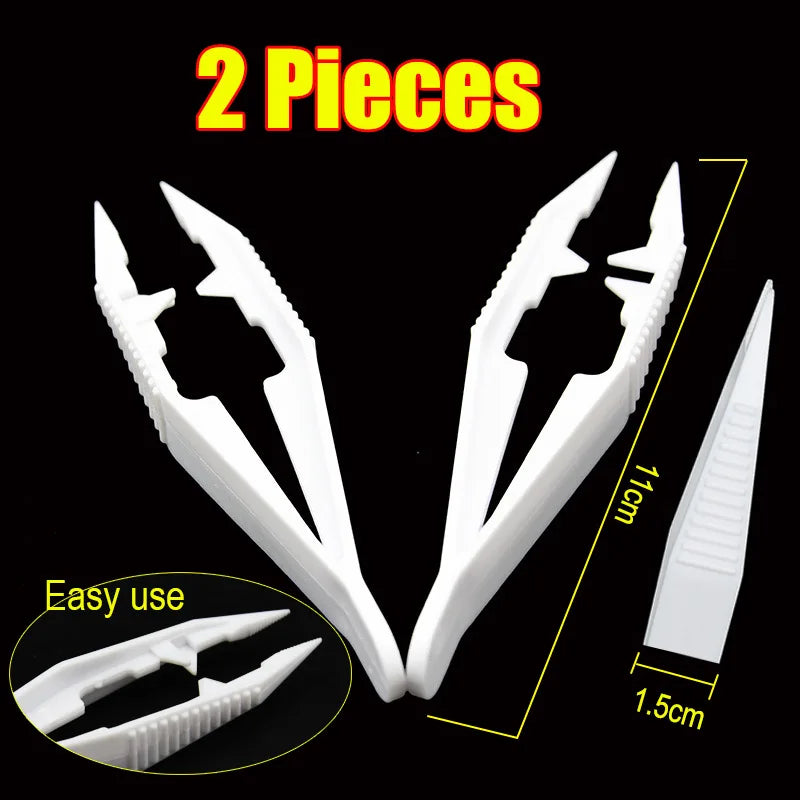 A set of two white precision tweezers for use in beadwork or crafting.