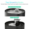 A black automatic cat water fountain demonstrating two streaming modes: a simulation gushing style and a water flow style.