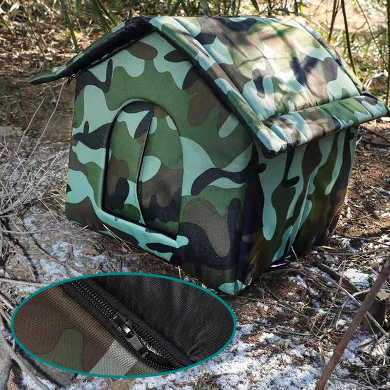 Maison de chat extérieure vert camouflage avec toit rembourré, dans un environnement boisé.