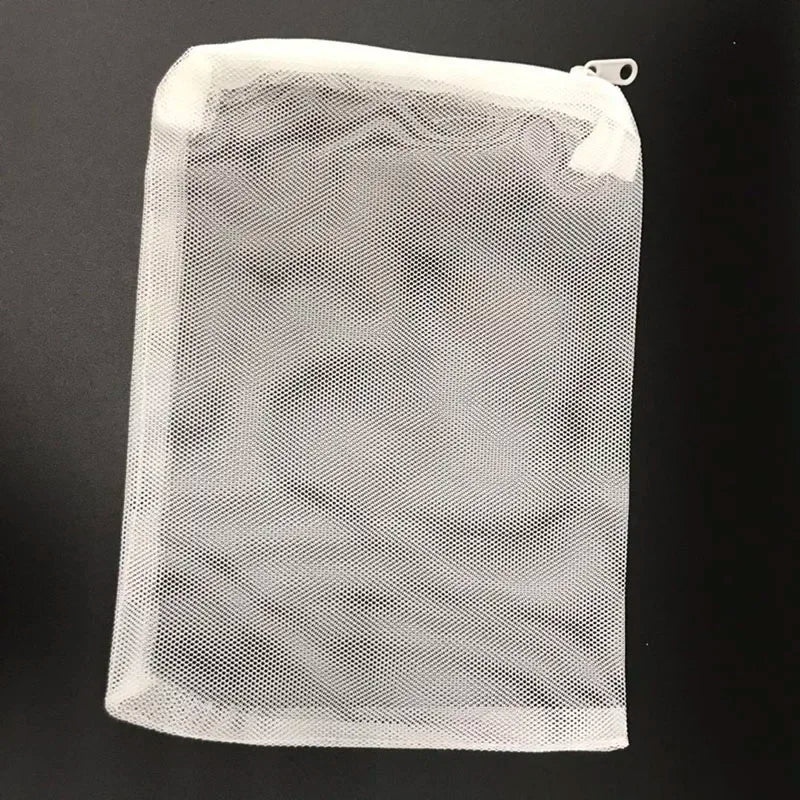A clear mesh bag containing aquarium filter media.