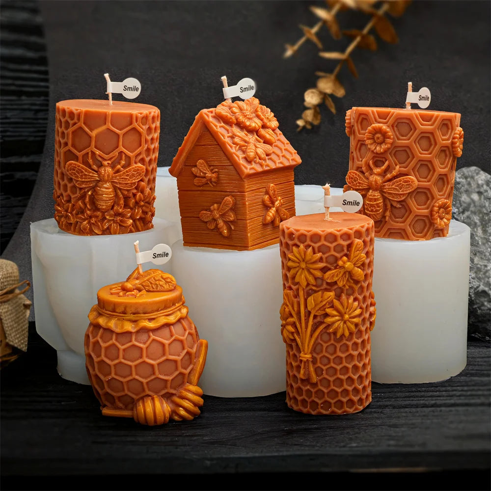 Several orange honeycomb silicone molds for candles and crafts are displayed on a dark surface.