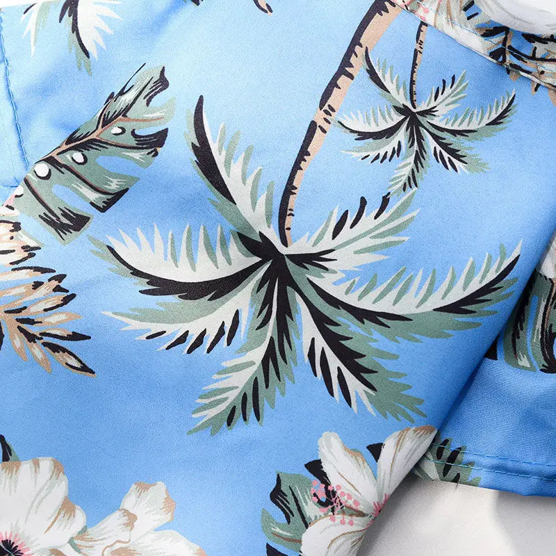 T-shirt pour chien style hawaïen bleu clair avec motif de feuilles de palmier vert et blanc