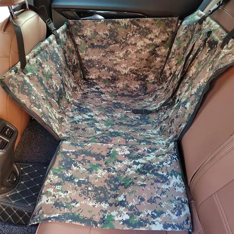 A camouflage patterned hammock cover for a pet car seat is shown inside a vehicle interior.