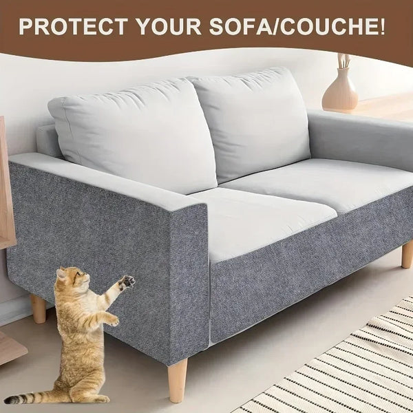 A gray sofa is protected by a self-adhesive cat scratch protection mat, with a cat paw visible on the mat.