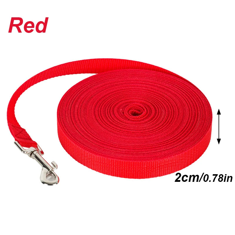 Red nylon dog training leash with solid color long lead rolled up