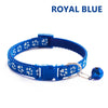Royal blue adjustable pet collar with a paw print pattern and a bell attached.