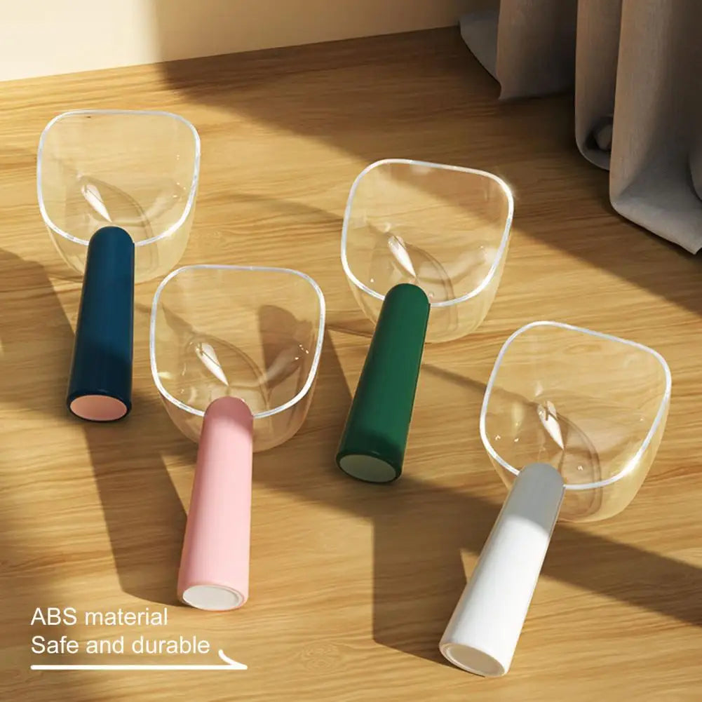 A set of clear and colored plastic measuring scoops for pet food, including a spoon and a scoop.