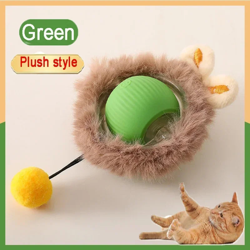 A green plush toy ball with a fluffy outer layer and a yellow ball is shown next to a cat.