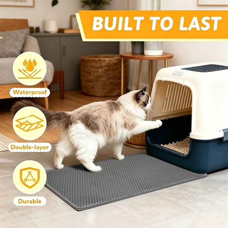 A beige cat is walking on a gray litter mat in front of a white pet litter box.