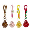 Refillable pet hair keychain featuring a cat paw charm in brown, pink, and red colors.