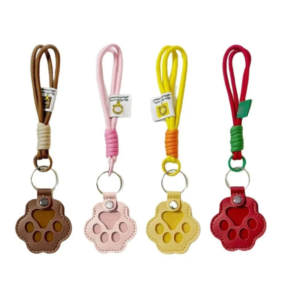 Refillable pet hair keychain featuring a cat paw charm in brown, pink, and red colors.