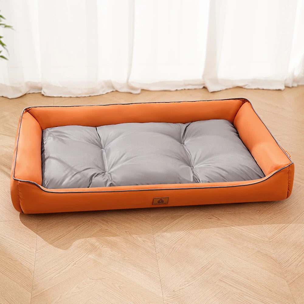 An orange corduroy pet sofa bed for dogs and cats resting on a light wooden floor.
