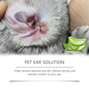 Close-up of a cat's ear with natural pet ear cleaning solution drops being applied.