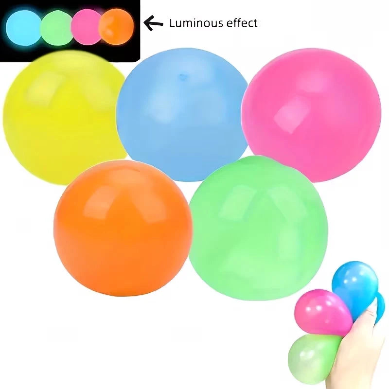 A collection of glow-in-the-dark sticky sensory balls in various colors including blue, yellow, pink, and green.