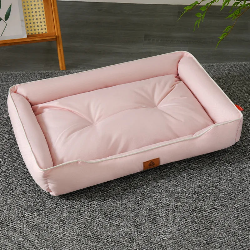 A pink, rectangular pet sofa bed for dogs and cats resting on a gray carpet.