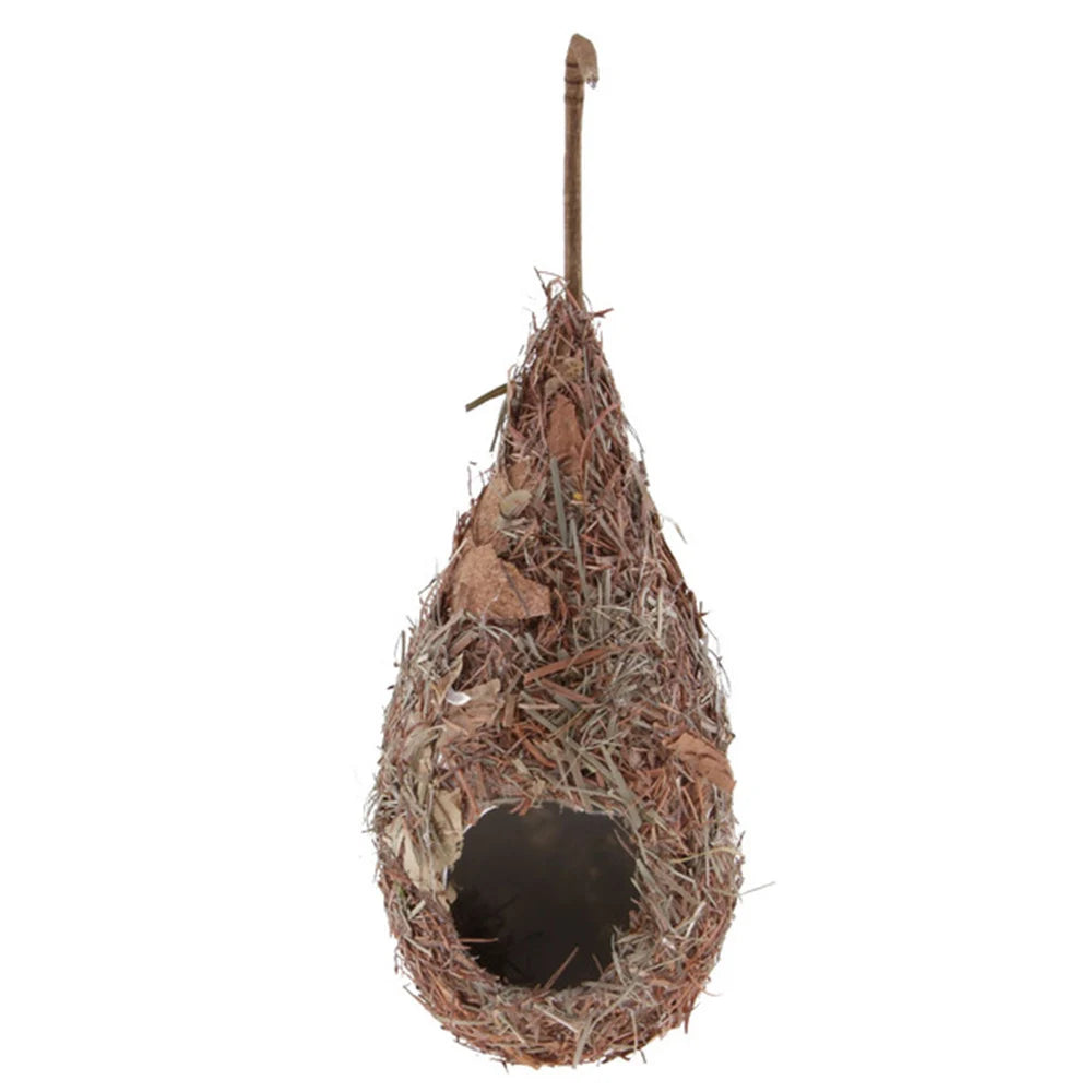Hand-woven grass bird nest decoration with a thin stick protruding from the top