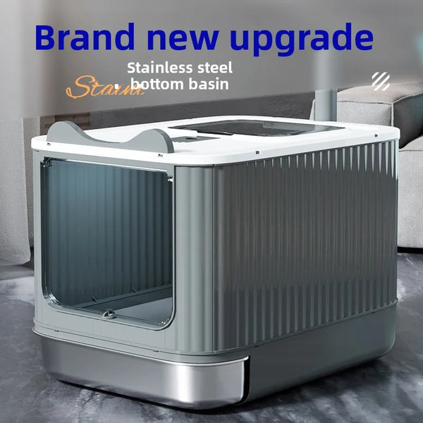 A modern stainless steel cat litter box with a clear viewing panel sits on a gray floor.