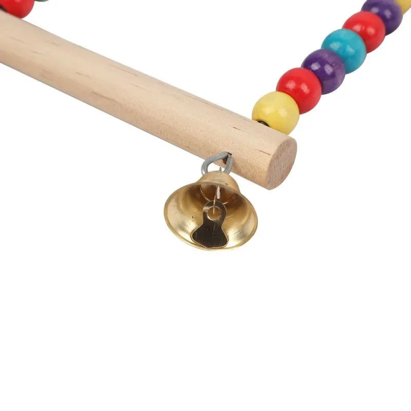 A wooden bird swing featuring colorful bells attached to a wooden dowel.